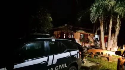 Viatura da Polícia Civil em frente a um imóvel durante fiscalização noturna.